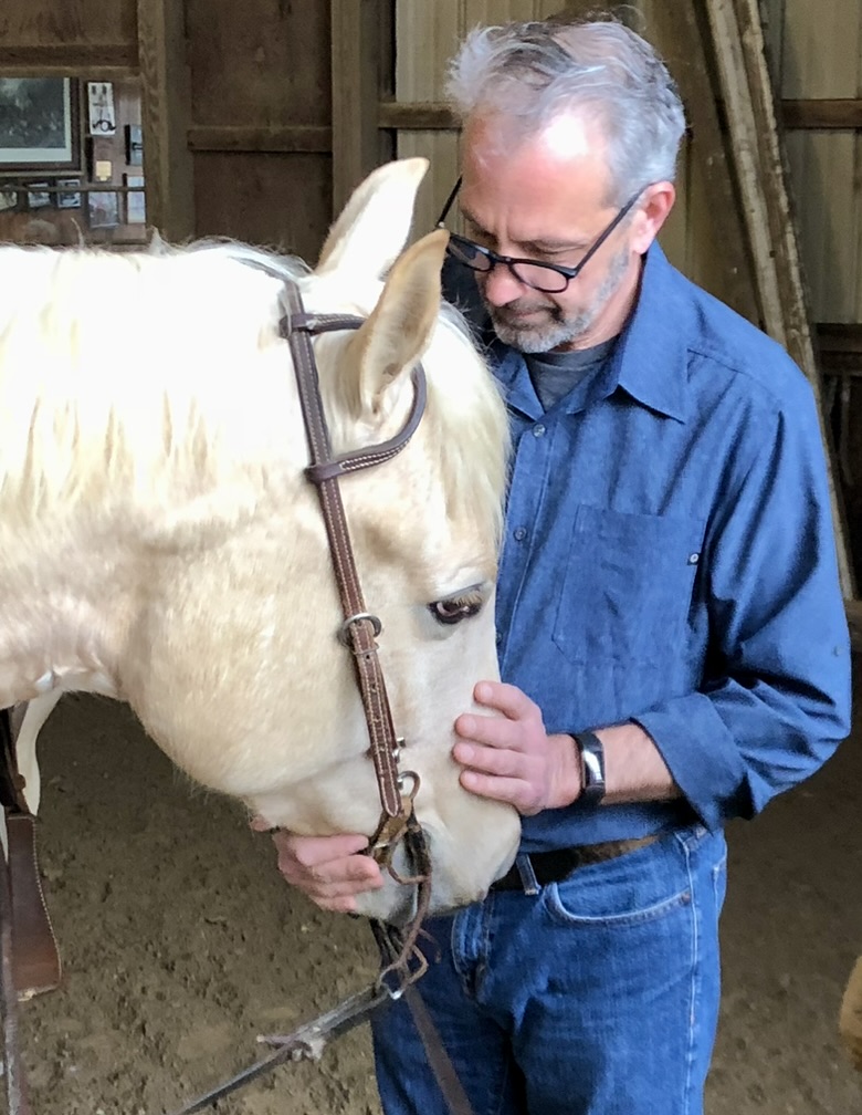 James working with a wonderful whit horse in his barn in Ct.